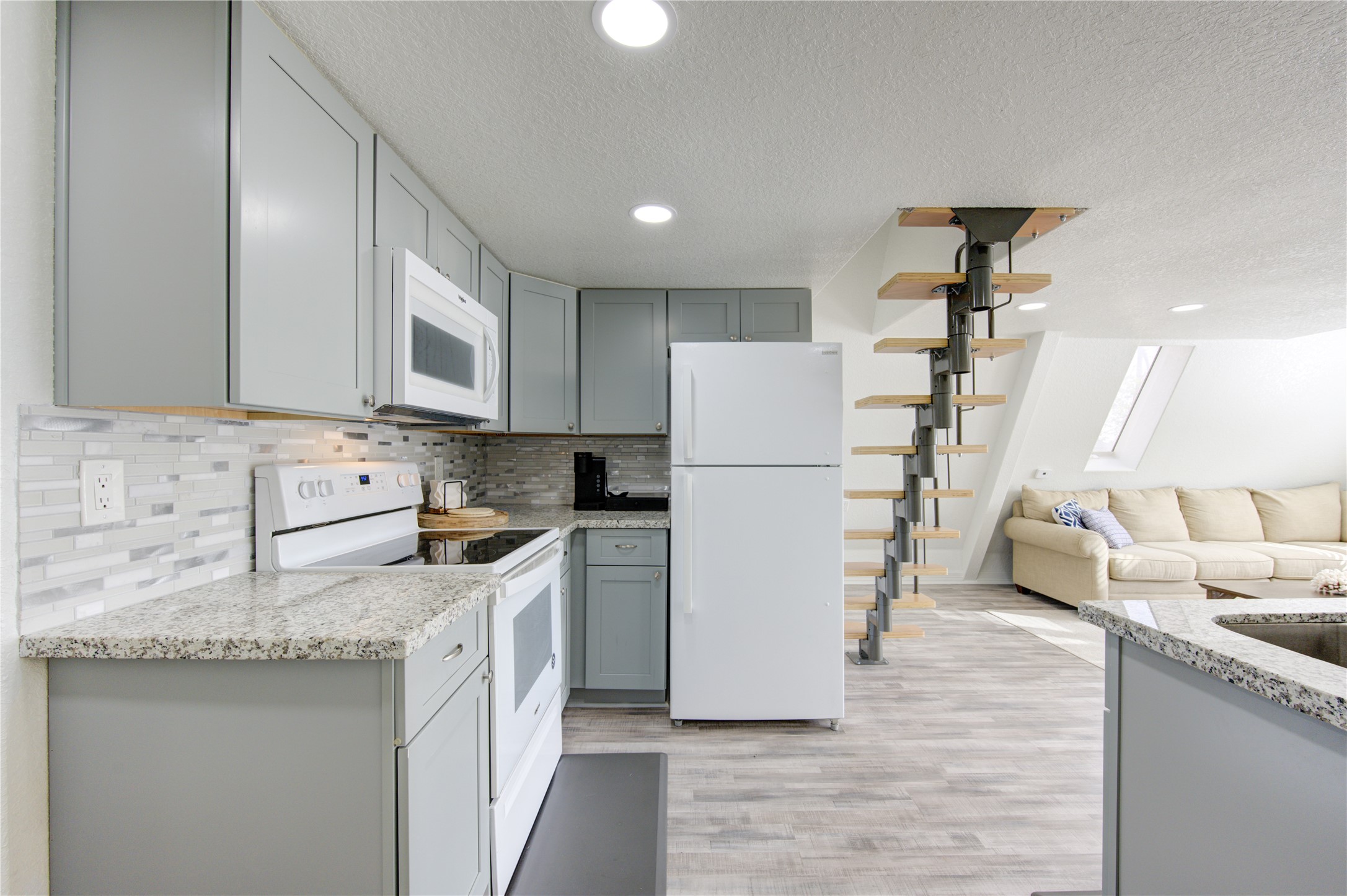 239 Redfish Drive Freeport, TX 77541 - Photo 10 of 25 a kitchen with kitchen island a sink a stove a refrigerator and cabinets