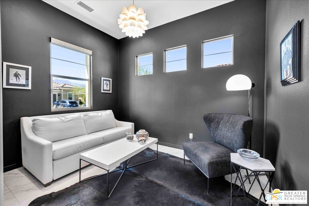 64 Claret Road Rancho Mirage, CA 92270 - Photo 14 of 30 a living room with furniture and a chandelier