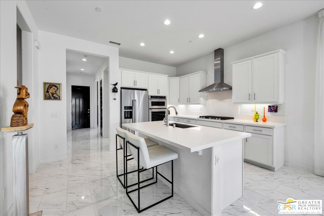 64 Claret Road Rancho Mirage, CA 92270 - Photo 15 of 30 a kitchen with stainless steel appliances a sink stove and refrigerator
