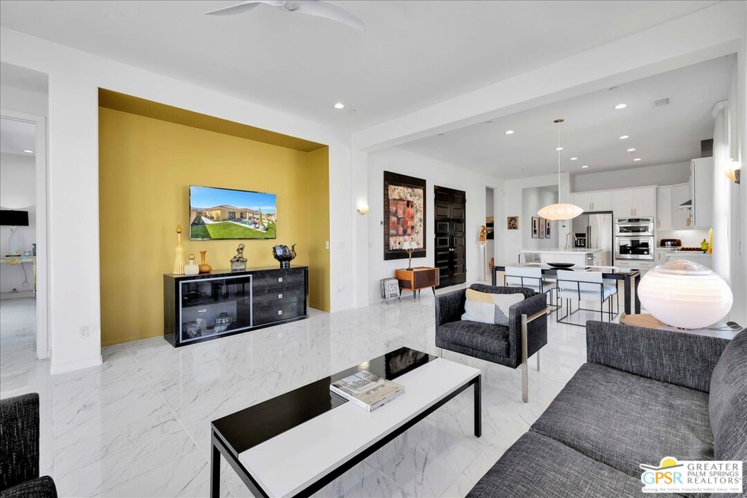 64 Claret Road Rancho Mirage, CA 92270 - Photo 20 of 30 a living room with furniture and a flat screen tv