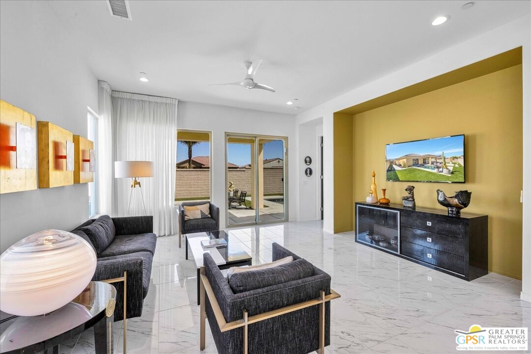 64 Claret Road Rancho Mirage, CA 92270 - Photo 2 of 30 a living room with furniture and a flat screen tv