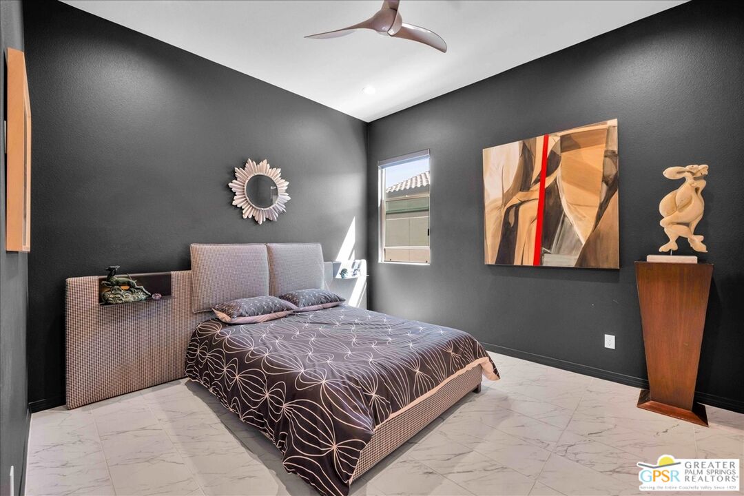 64 Claret Road Rancho Mirage, CA 92270 - Photo 23 of 30 a bedroom with a bed and a painting on the wall