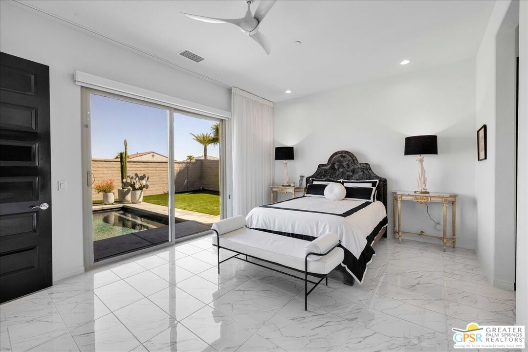 64 Claret Road Rancho Mirage, CA 92270 - Photo 4 of 30 a living room with furniture and a flat screen tv