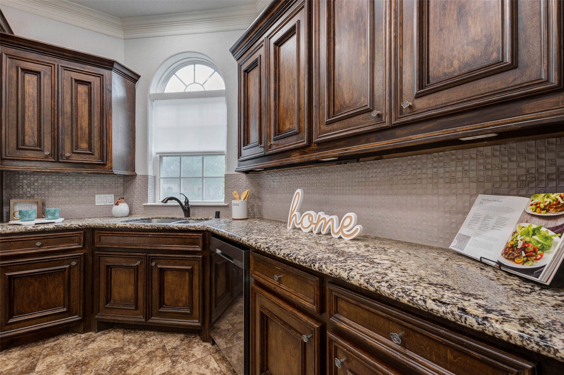 5327 Whitmore Fulshear, TX 77441 - Photo 18 of 50 Rich cabinetry, expansive granite countertops, and abundant storage ensure this beautifully appointed kitchen is ready for everything from casual meals to holiday gatherings.