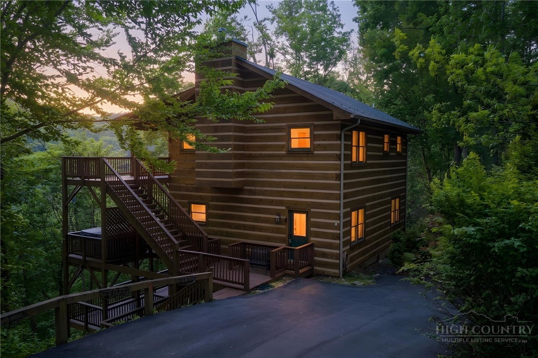 a backyard of a house with wooden fence and trees