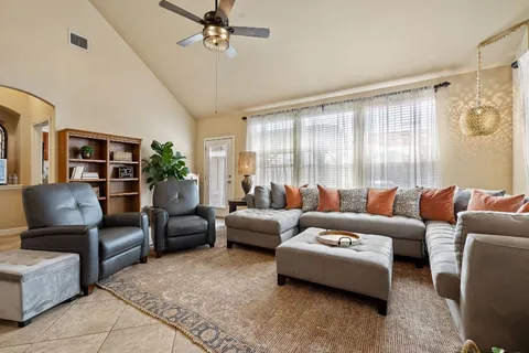 a living room with furniture and a large window