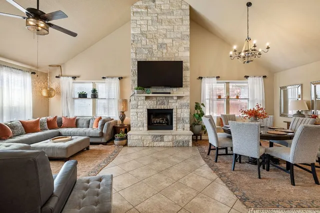 a living room with furniture a flat screen tv and a fireplace