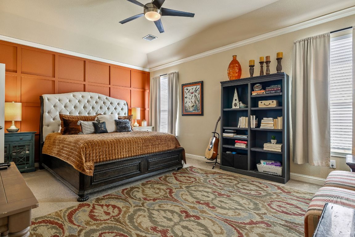 2494 Santa Barbara Loop Round Rock, TX 78665 - Photo 22 of 35 a bedroom with a bed a dresser and a book shelf