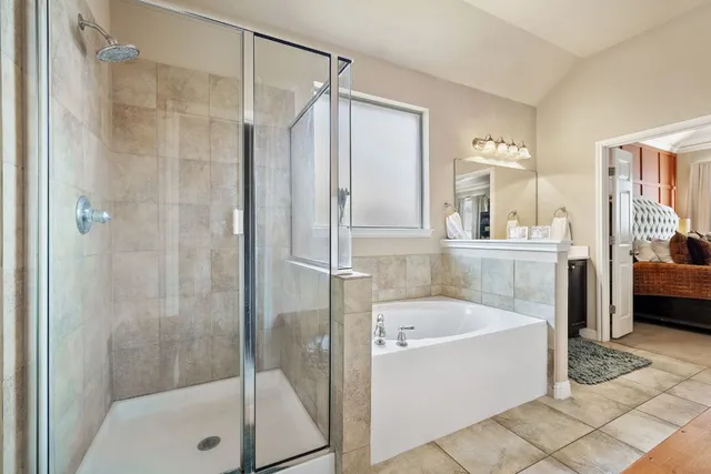a bathroom with a tub a sink and a shower