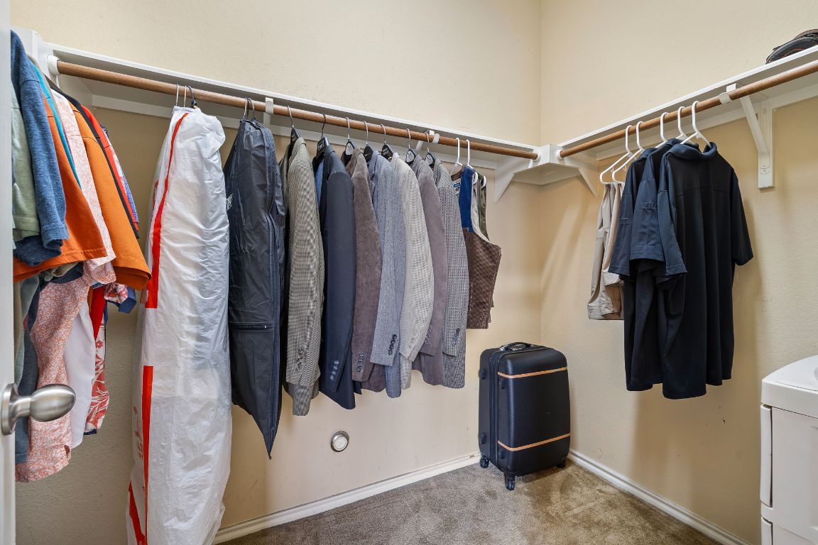 2494 Santa Barbara Loop Round Rock, TX 78665 - Photo 25 of 35 a view of walk in closet with clothes and shoes