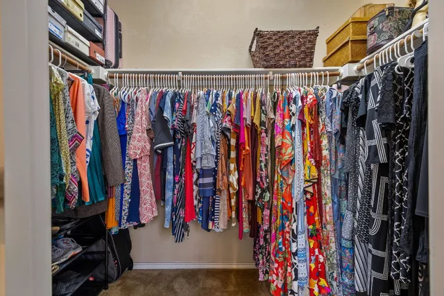 a view of walk in closet with clothes