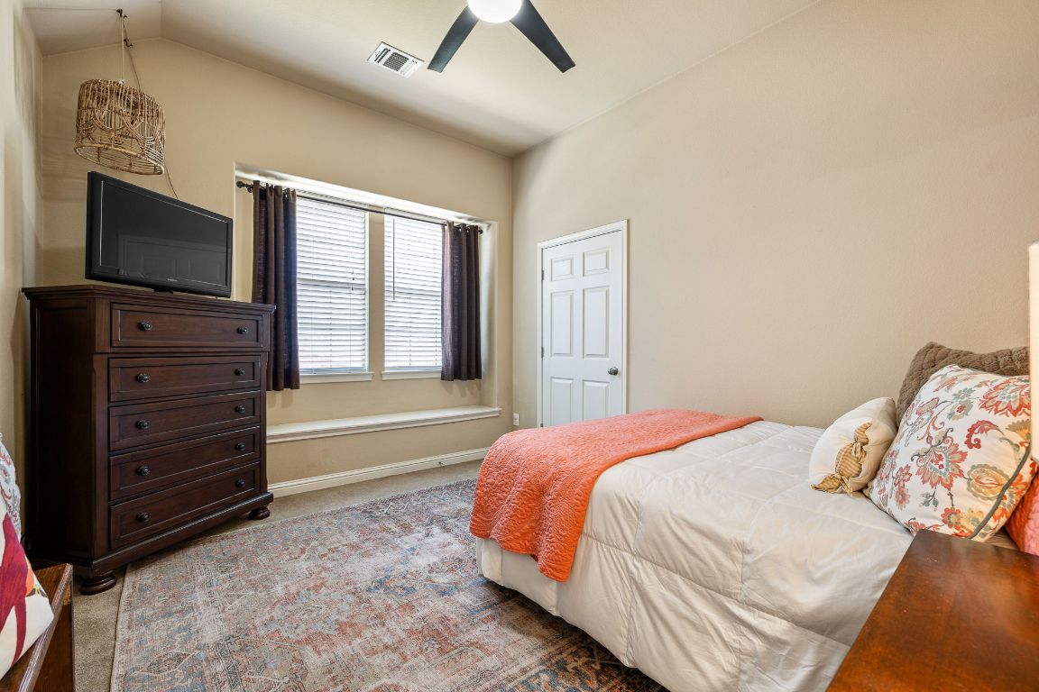 2494 Santa Barbara Loop Round Rock, TX 78665 - Photo 27 of 35 a bedroom with a bed and a flat screen tv