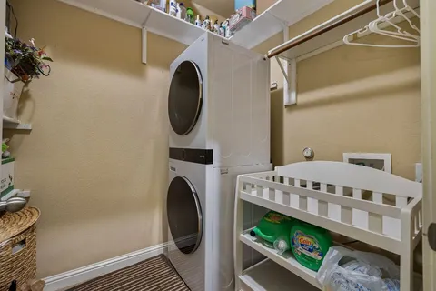 a view of a patio with table and chairs under an umbrella