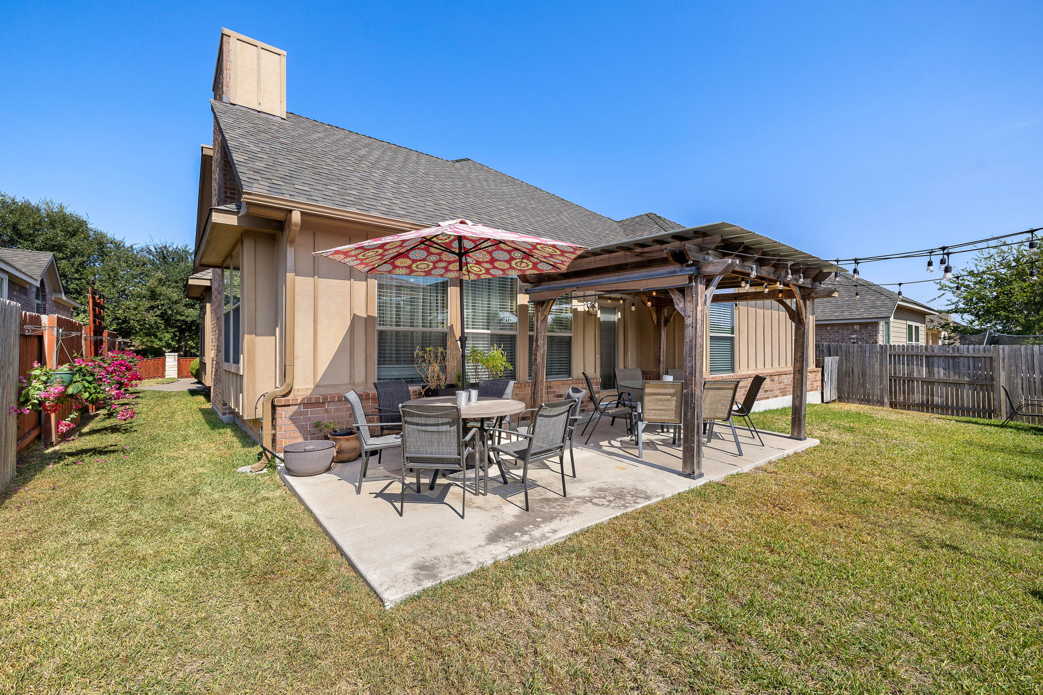 2494 Santa Barbara Loop Round Rock, TX 78665 - Photo 32 of 35 a view of a patio with table and chairs under an umbrella