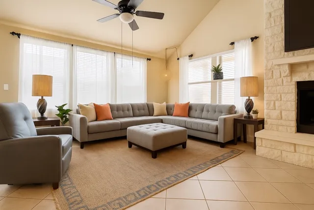 a living room with furniture a large window and a flat screen tv