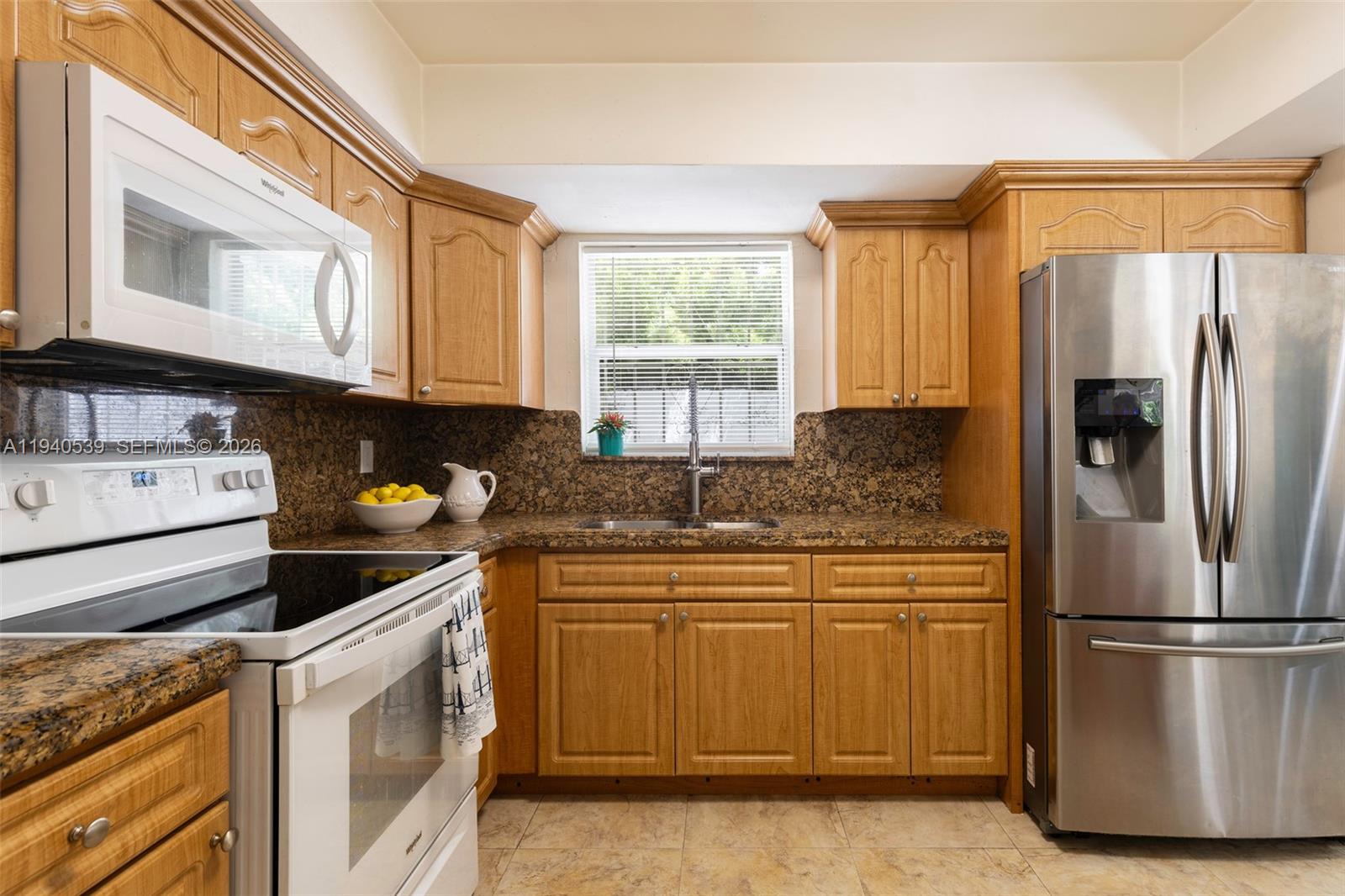 2201 Southwest 22nd Terrace Miami, FL 33145 - Photo 13 of 25 a kitchen with a refrigerator sink and cabinets