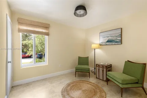 a view of a livingroom with furniture and a window