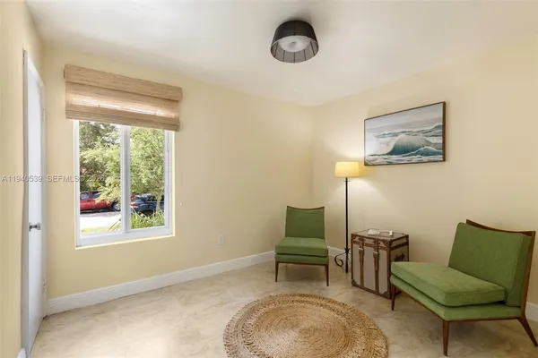 a view of a livingroom with furniture and a window