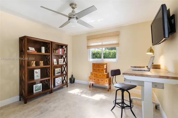 a workspace with furniture window and a ceiling fan