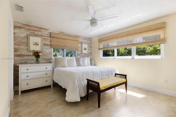a bedroom with a bed and a window dresser