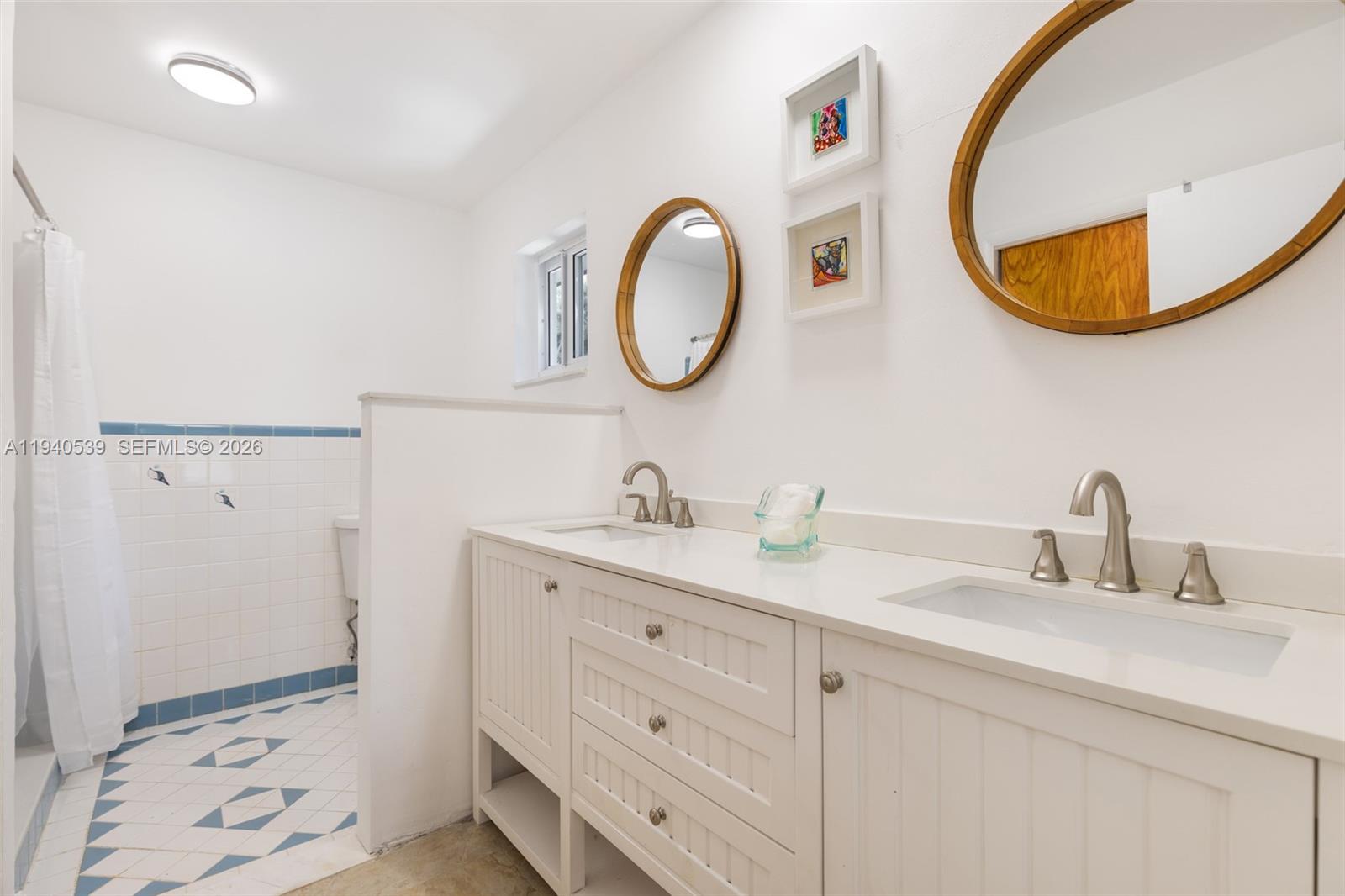 2201 Southwest 22nd Terrace Miami, FL 33145 - Photo 20 of 25 a bathroom with a granite countertop sink and a mirror