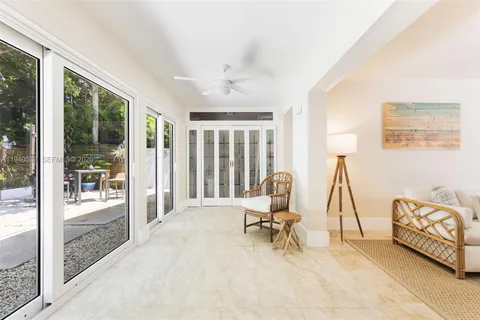 a view of a livingroom with lounge chair and a large window