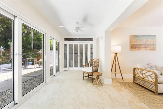 a view of a livingroom with lounge chair and a large window