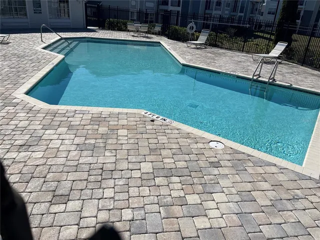 a view of a backyard with plants and patio