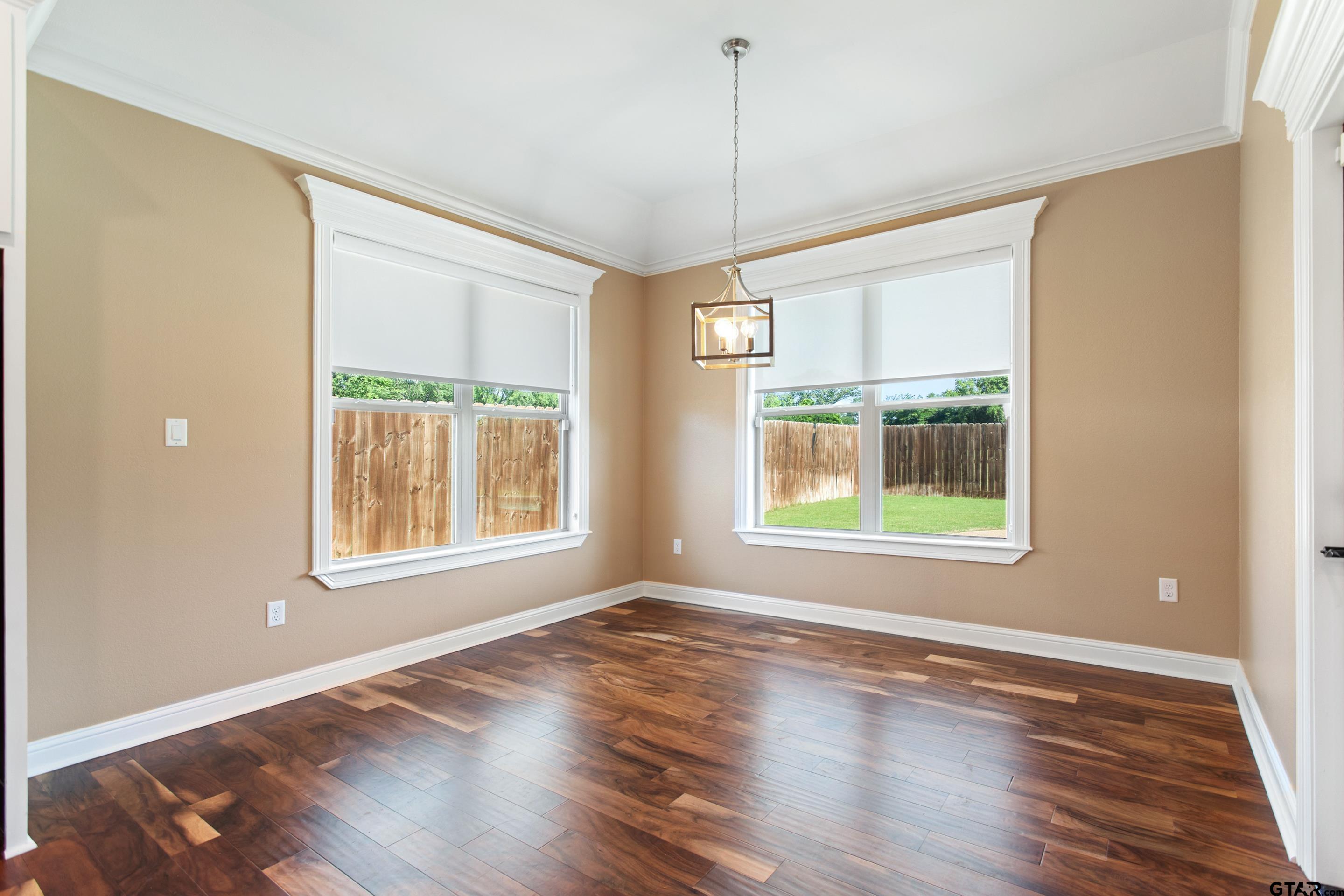 105 Nathan Road Chandler, TX 75758 - Photo 12 of 36 a view of an empty room with wooden floor and a window