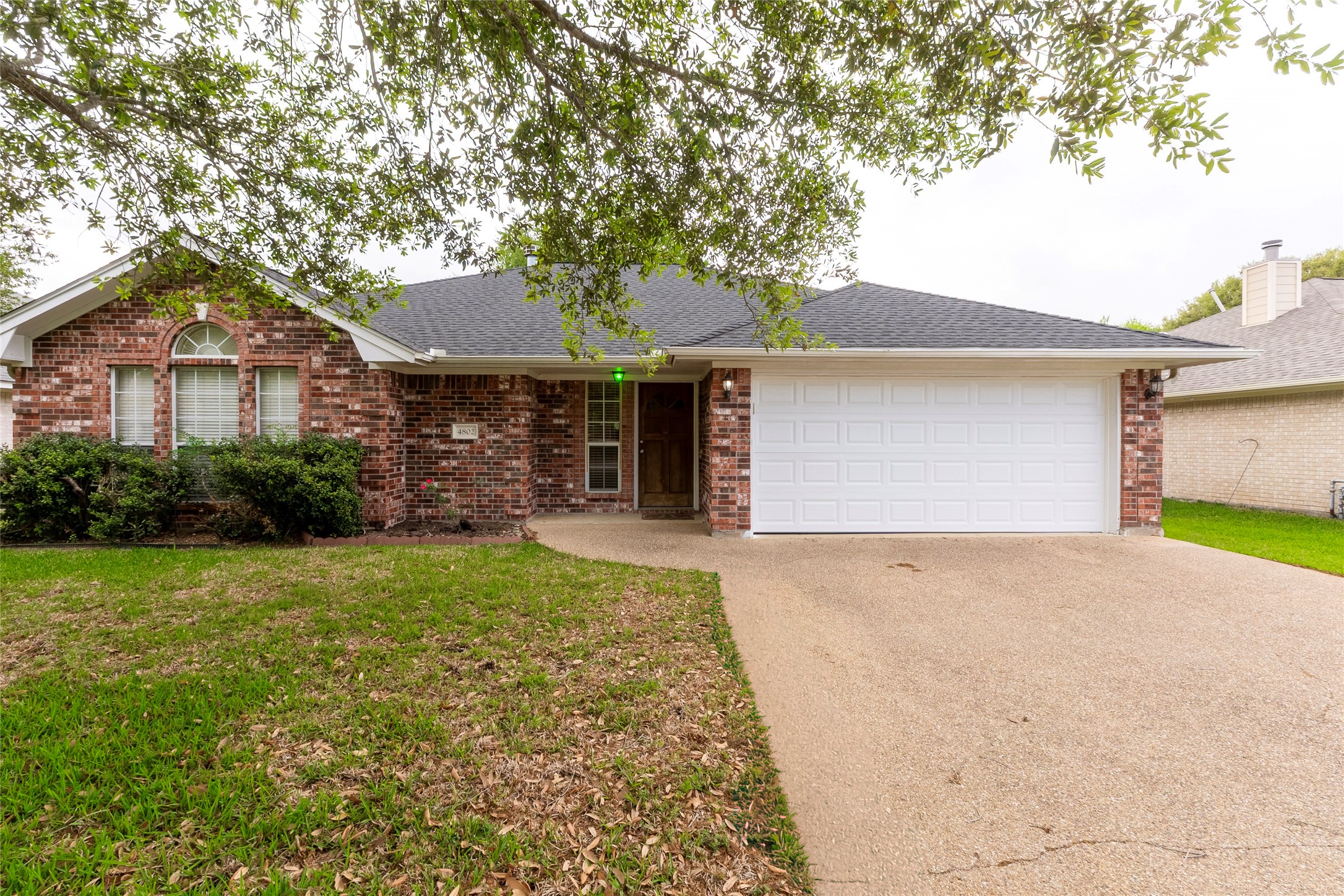 4802 Treadgold Lane Bryan, TX 77802 - Photo 2 of 27 a front view of a house with garden