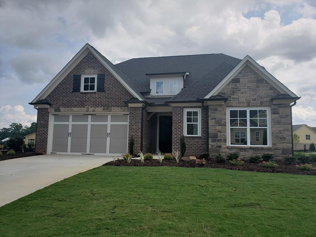 3810 Raeburn Road Cumming, GA 30028 - Photo 1 of 1 a front view of a house with a yard and porch