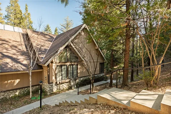 a view of a house with large trees