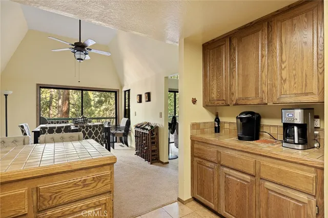 a kitchen with a stove a refrigerator and cabinets