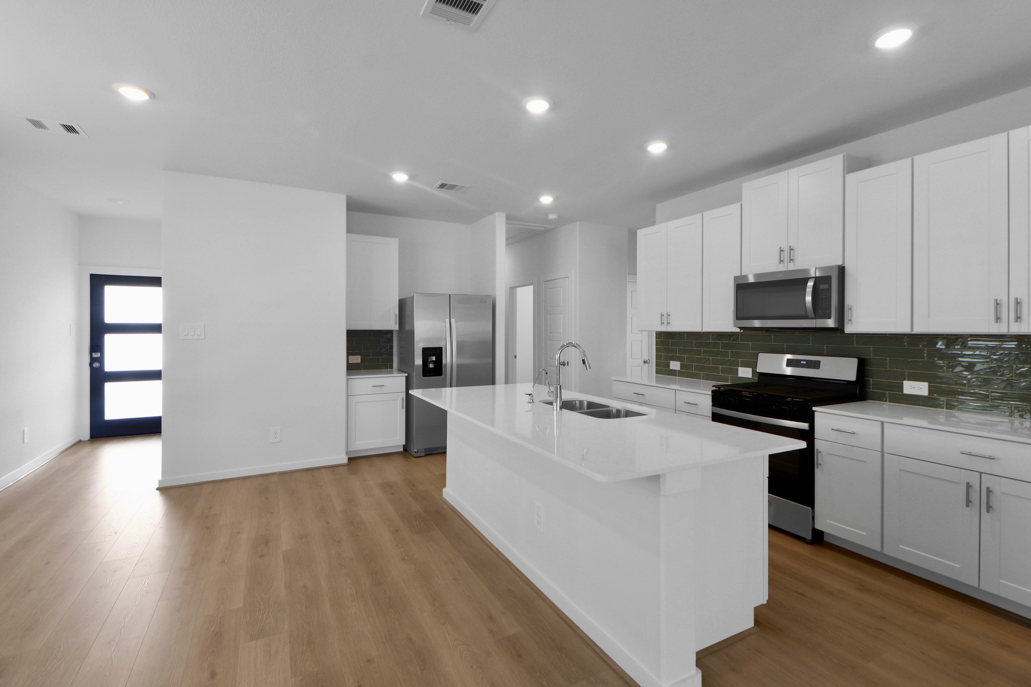 2614 Cactus Ranch Lane Crosby, TX 77532 - Photo 4 of 24 a large kitchen with stainless steel appliances granite countertop a stove a sink a refrigerator and white cabinets