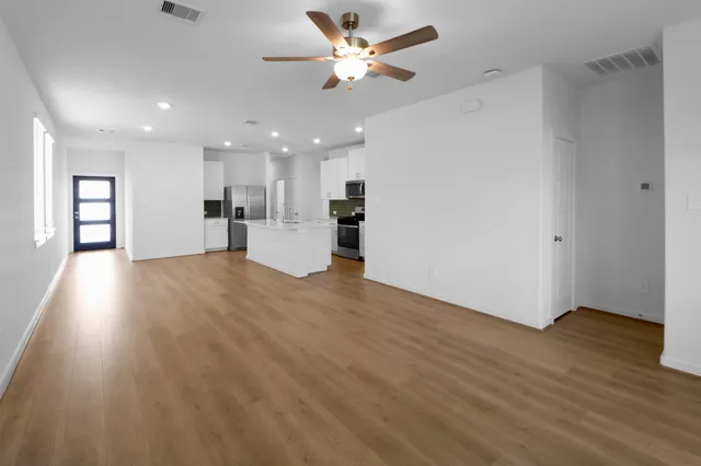 a view of a kitchen with a sink and a window