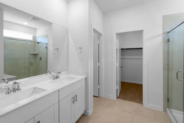 a bathroom with a double vanity sink mirror and double