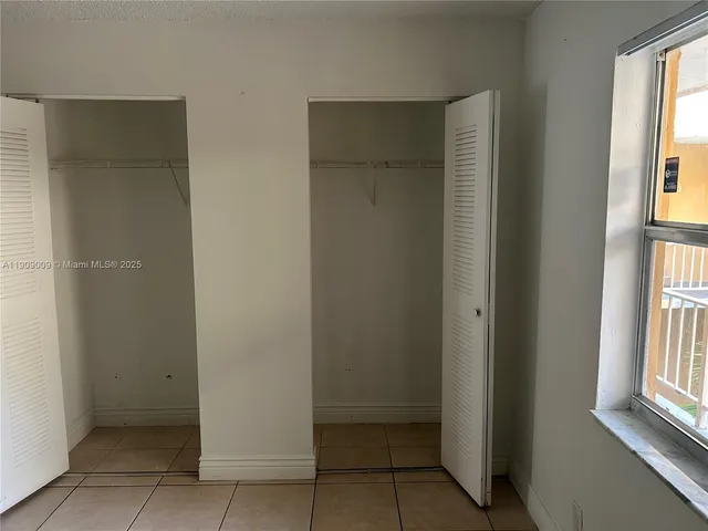 a view of an empty room with windows