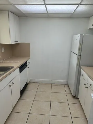 a kitchen with cabinets and white appliances