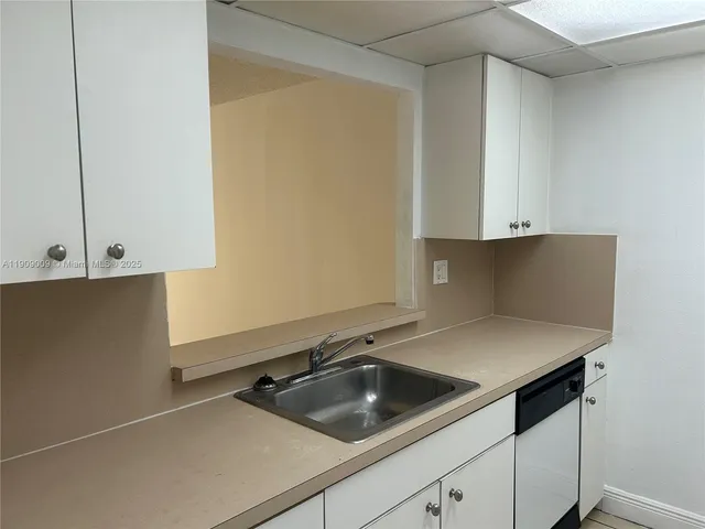 a kitchen with a sink and cabinets