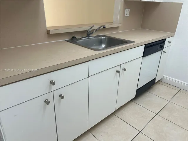 a kitchen with a sink and cabinets