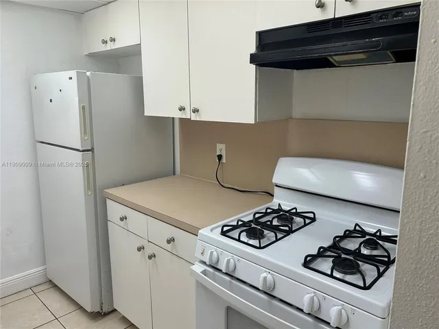 a kitchen with a stove and a refrigerator