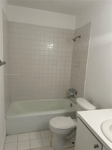a bathroom with a toilet and a bathtub