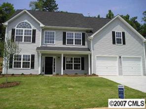 a view of a brick house with a yard