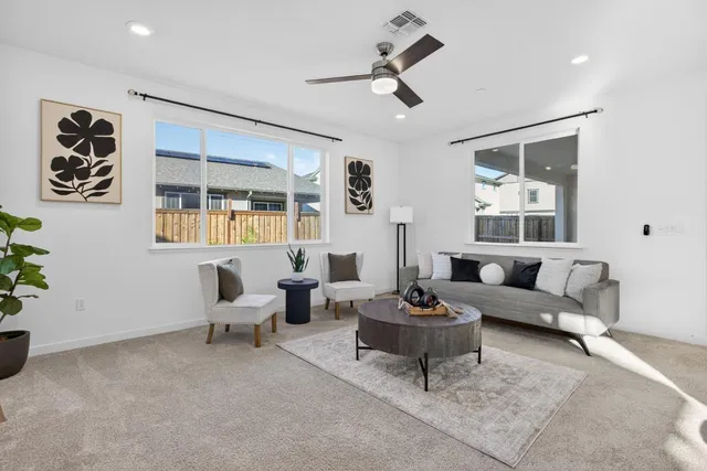 a kitchen with stainless steel appliances granite countertop a stove top oven a sink a dining table and chairs