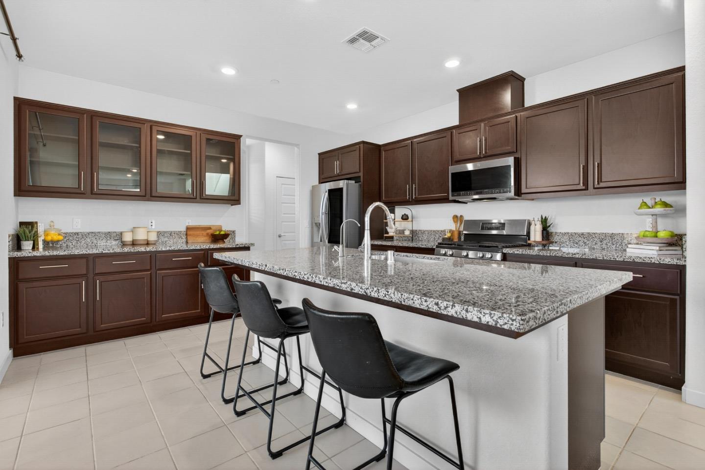17533 Pegasus Court Lathrop, CA 95330 - Photo 18 of 59 a kitchen with stainless steel appliances granite countertop a sink a stove a microwave a refrigerator and cabinets