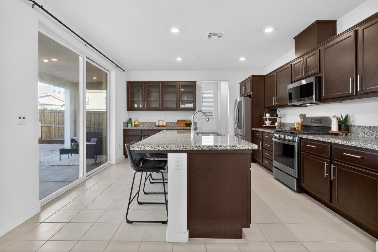 17533 Pegasus Court Lathrop, CA 95330 - Photo 19 of 59 a kitchen with stainless steel appliances granite countertop a sink counter space cabinets and a refrigerator