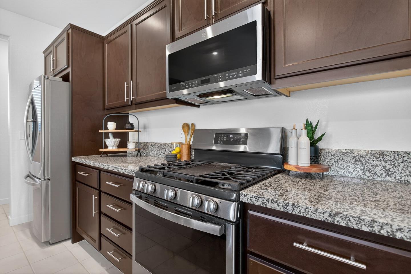 17533 Pegasus Court Lathrop, CA 95330 - Photo 20 of 59 a kitchen with stainless steel appliances granite countertop a stove and a microwave