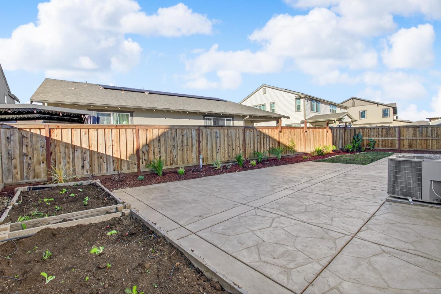 17533 Pegasus Court Lathrop, CA 95330 - Photo 44 of 59 a view of a patio with table and chairs with wooden fence