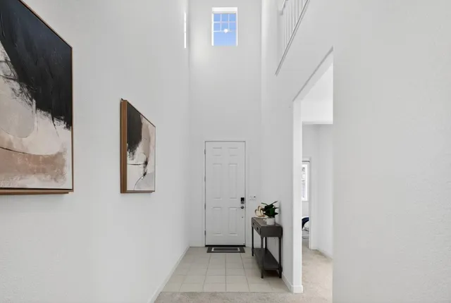 a bedroom with a bed and a painting on the wall