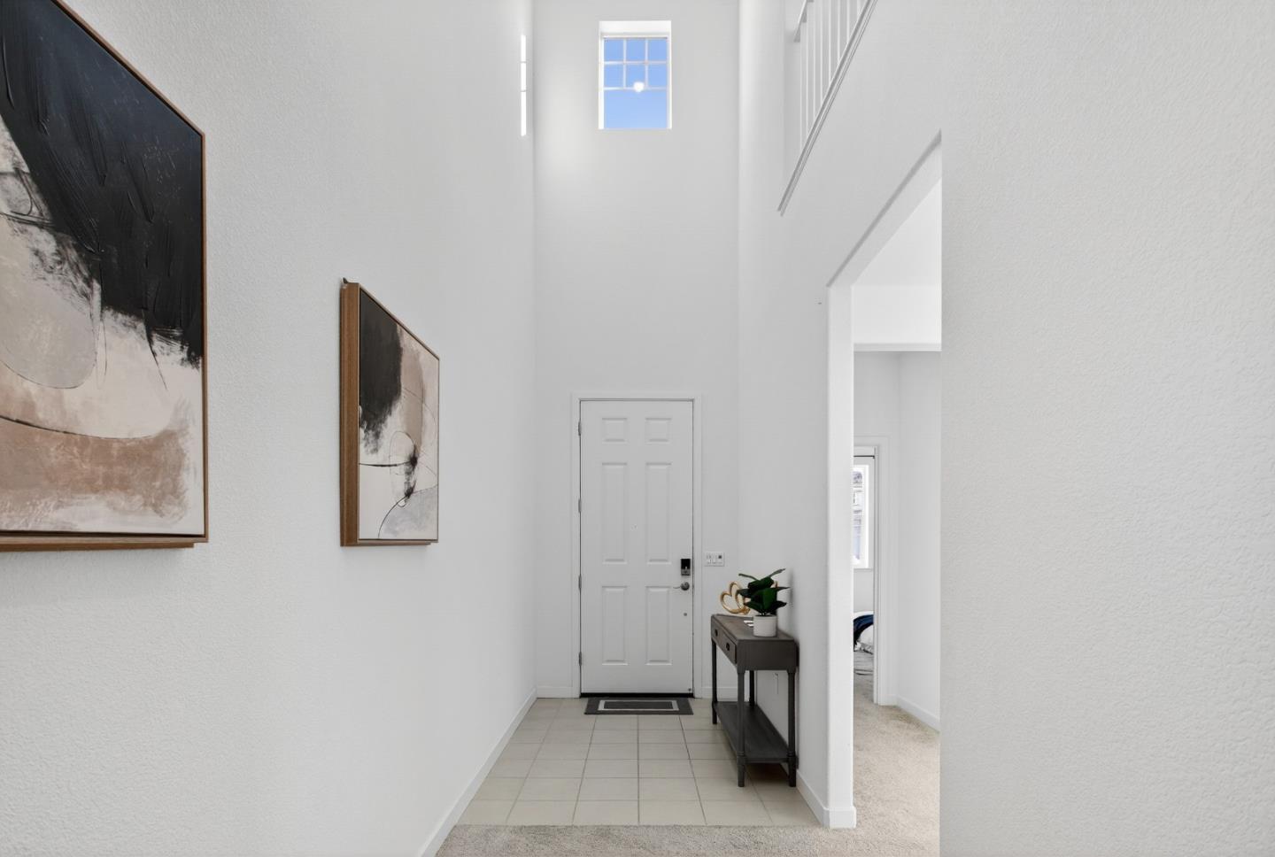 17533 Pegasus Court Lathrop, CA 95330 - Photo 6 of 59 a view of a hallway with paintings on the wall